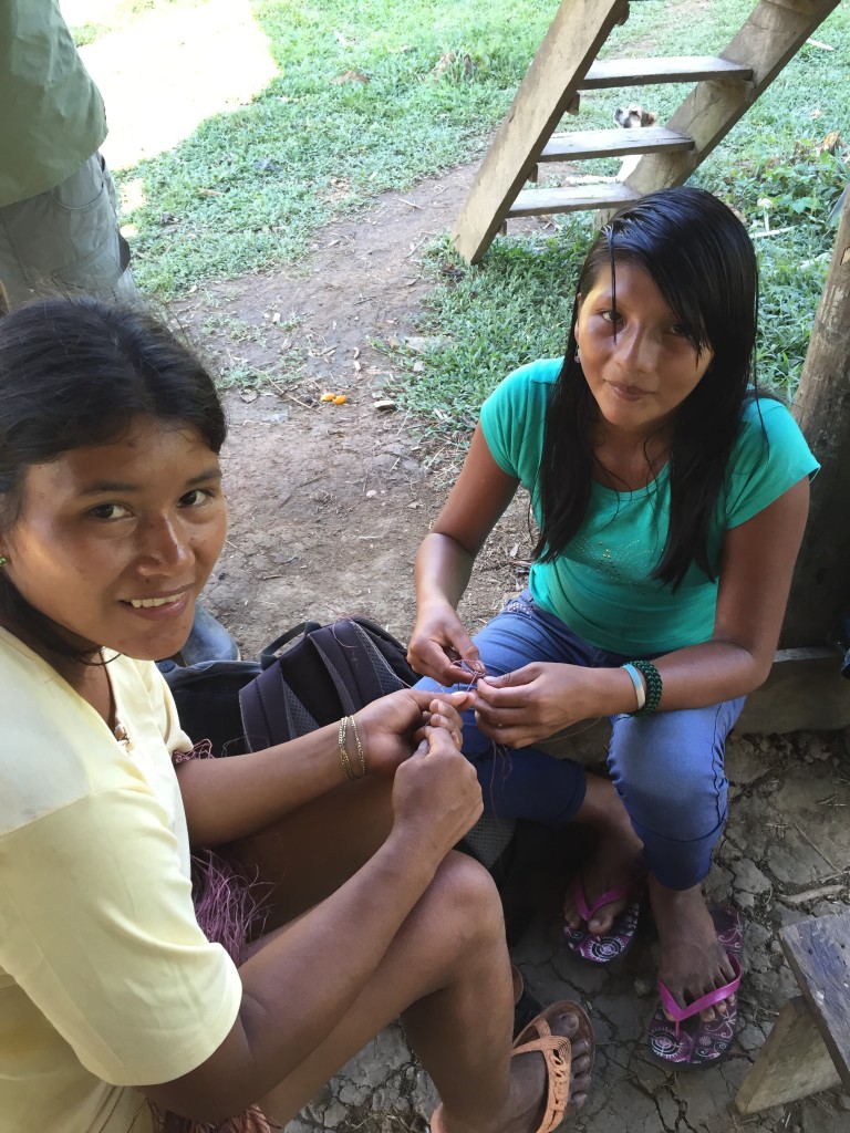 Bacha and her sister-in-law Angelica, weaving a bracelet